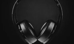 Black headphones against a dark background